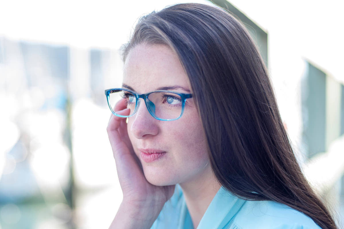 Pretty brunette woman wearing blue glasses frames by Mr Foureyes, profile shot